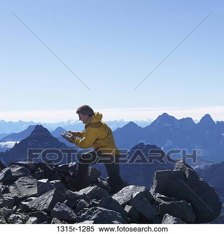 Canada, Alberta, Banff, mountaineer building rock cairn on summit, Banff, Alberta, Canada View Large Photo Image Stock Photography - Canada, Alberta, Banff, mountaineer building rock cairn on summit, Banff, Alberta, Canada. Fotosearch