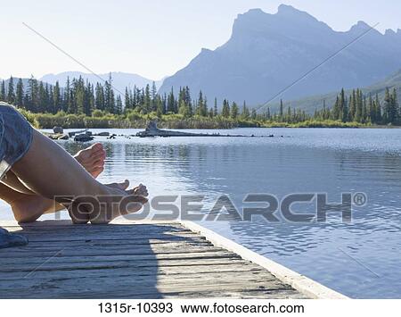 Canada, Alberta, Banff National Park, Feet of couple on wooden pier on Vermillion Lake, mountains in background View Large Photo Image Stock Image - Canada, Alberta, Banff National Park, Feet of couple on wooden pier on Vermillion Lake, mountains in background. Fotosearch