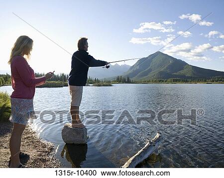 Canada, Alberta, Banff National Park, couple fishing on edge of Vermillion Lake View Large Photo Image Stock Image - Canada, Alberta, Banff National Park, couple fishing on edge of Vermillion Lake. Fotosearch