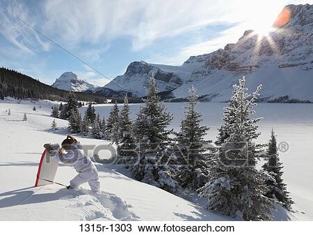 Canada, Alberta, Banff National Park, teenage girl hiking with boogie board through deep snow View Large Photo Image Stock Image - Canada, Alberta, Banff National Park, teenage girl hiking with boogie board through deep snow. Fotosearch