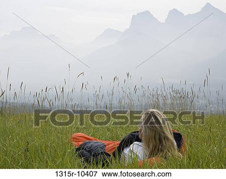 Canada, Alberta, Banff National Park, Woman in sleeping bag in alpine meadow View Large Photo Image Stock Photo - Canada, Alberta, Banff National Park, Woman in sleeping bag in alpine meadow. Fotosearch