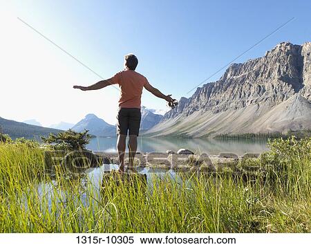 Canada, Alberta, Banff National Park, Man balancing on log in Bow lake View Large Photo Image Stock Photography - Canada, Alberta, Banff National Park, Man balancing on log in Bow lake. Fotosearch