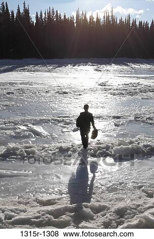 Canada, Alberta, businessman crossing ice jam on frozen river View Large Photo Image Stock Photo - Canada, Alberta, businessman crossing ice jam on frozen river. Fotosearch