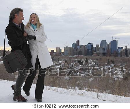Canada, Alberta, Calgary, Couple walking in snow above city View Large Photo Image Stock Image - Canada, Alberta, Calgary, Couple walking in snow above city. Fotosearch