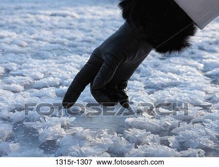 Canada, Alberta, close up of woman's gloved finger touching ice crystals View Large Photo Image Stock Photo - Canada, Alberta, close up of woman's gloved finger touching ice crystals. Fotosearch