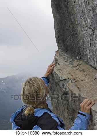 Canada, Alberta, Female climber traversing steep rock ledge View Large Photo Image Stock Image - Canada, Alberta, Female climber traversing steep rock ledge. Fotosearch