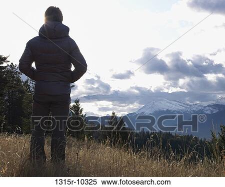 Canada, Alberta, Man standing in mountain meadow View Large Photo Image Stock Photography - Canada, Alberta, Man standing in mountain meadow. Fotosearch