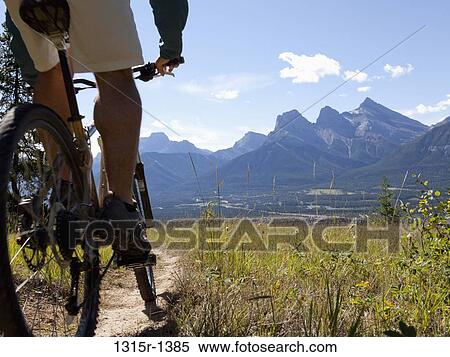Stock Photography - Canada, Alberta, mountain biker on trail. Fotosearch
