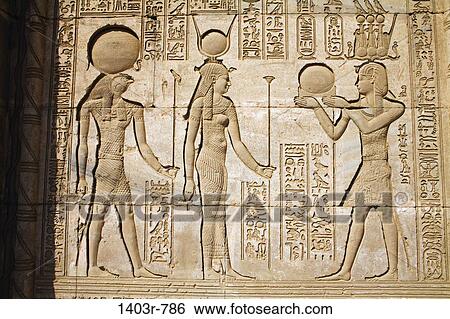 Stock Photograph - Carved reliefs on the outside of the Roman Mammisi at the Dendera Temple Complex in Egypt. Fotosearch