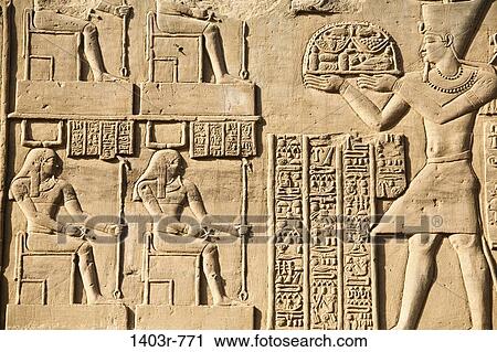 Carvings on a wall at the Temple of Horus and Sobek in the ancient ruins of Kom Ombo on the Nile River in southern Egypt View Large Photo Image Stock Image - Carvings on a wall at the Temple of Horus and Sobek in the ancient ruins of Kom Ombo on the Nile River in southern Egypt. Fotosearch