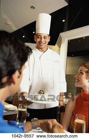 Stock Photo - Chef serving food in a restaurant. Fotosearch