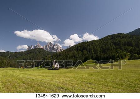 Church with mountain range in the background, St. Johann Church, Funes Valley, Dolomites, Trentino-Alto-Adige, Italy View Large Photo Image Stock Photo - Church with mountain range in the background, St. Johann Church, Funes Valley, Dolomites, Trentino-Alto-Adige, Italy. Fotosearch