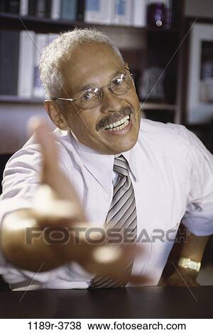 Close-up of a businessman holding his hand out View Large Photo Image Stock Photo - Close-up of a businessman holding his hand out. Fotosearch