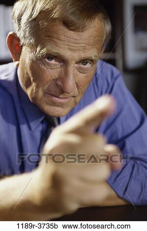 Stock Image - Close-up of a businessman pointing forward. Fotosearch