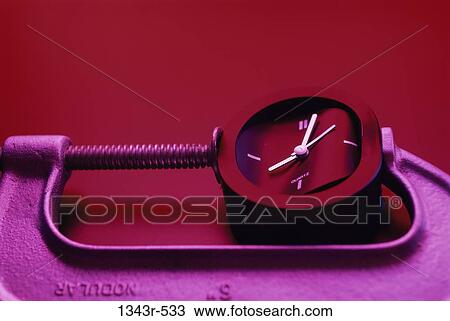 Close-up of a clock being squeezed in a clamp View Large Photo Image Stock Image - Close-up of a clock being squeezed in a clamp. Fotosearch