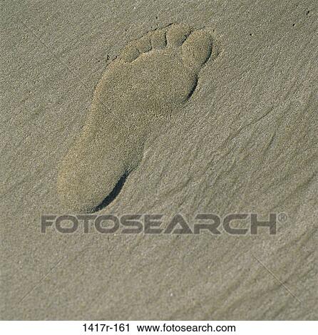 Stock Image - Close-up of a footprint in the sand at the beach. Fotosearch