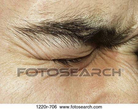 Stock Photograph - Close-up of a man's closed eye. Fotosearch