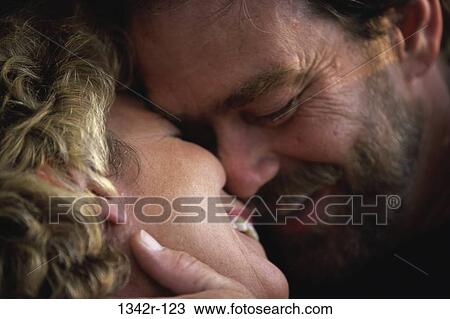 Close-up of a mid adult couple kissing View Large Photo Image Stock Image - Close-up of a mid adult couple kissing. Fotosearch