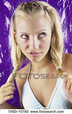 Close-up of a teenage girl holding her pigtails View Large Photo Image Stock Image - Close-up of a teenage girl holding her pigtails. Fotosearch