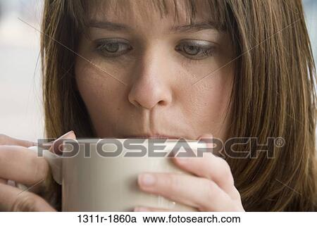 Close-up of a young woman drinking coffee View Large Photo Image Stock Image - Close-up of a young woman drinking coffee. Fotosearch