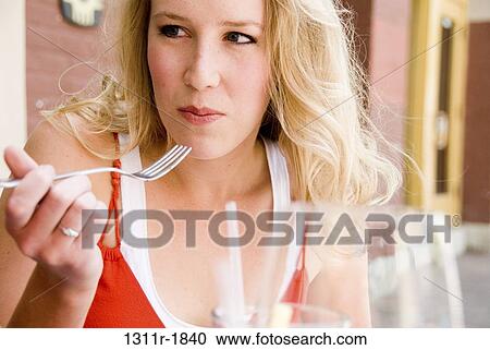 Close-up of a young woman eating food with a fork View Large Photo Image Stock Image - Close-up of a young woman eating food with a fork. Fotosearch