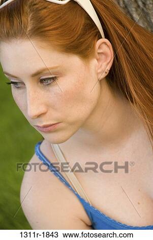 Close-up of a young woman looking serious View Large Photo Image Stock Image - Close-up of a young woman looking serious. Fotosearch