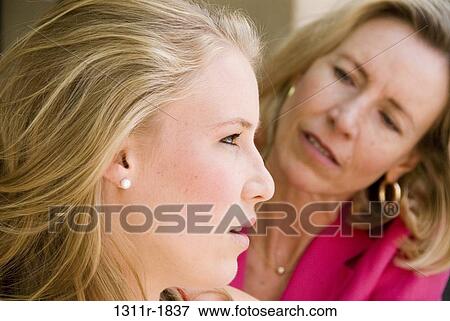Close-up of a young woman with her mother View Large Photo Image Stock Photo - Close-up of a young woman with her mother. Fotosearch