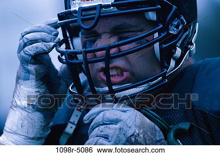 Close-up of an American football player wearing a helmet View Large Photo Image Stock Photograph - Close-up of an American football player wearing a helmet. Fotosearch