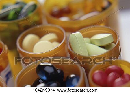 Close-up of an assortment of tablets and capsules in vials View Large Photo Image Picture - Close-up of an assortment of tablets and capsules in vials. Fotosearch