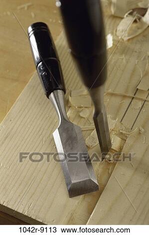 Stock Image - Close-up of chisels on wood. Fotosearch