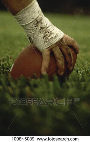 Close-up of the hand of an American football player holding a football View Large Photo Image Stock Photo - Close-up of the hand of an American football player holding a football. Fotosearch