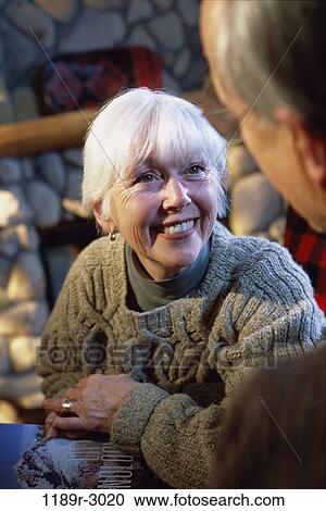 Close-up of two senior women sitting and smiling View Large Photo Image Stock Image - Close-up of two senior women sitting and smiling. Fotosearch