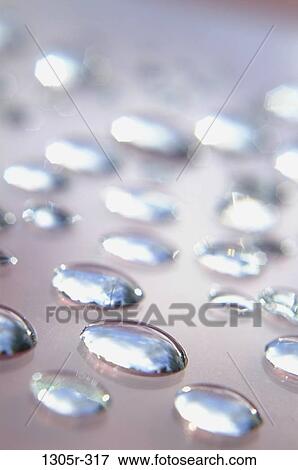 Close-up of water droplets on a surface View Large Photo Image Stock Photo - Close-up of water droplets on a surface. Fotosearch