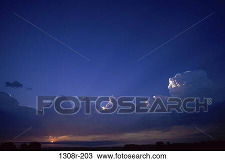 Stock Image - Clouds over the ocean at sunset. Fotosearch