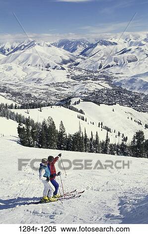 Stock Photography - Couple skiing on Bald Mountain, Sun Valley, Idaho, USA. Fotosearch