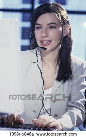 Stock Image - Customer service representative wearing a headset. Fotosearch