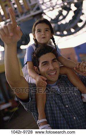 Stock Photo - Daughter sitting on her father's shoulder. Fotosearch