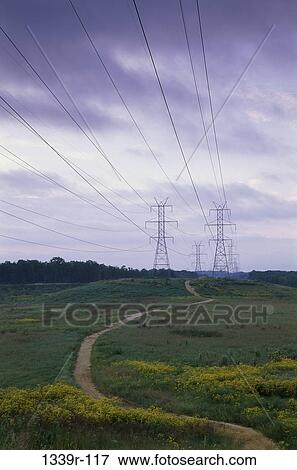Stock Photo - Electricity pylons in a field. Fotosearch