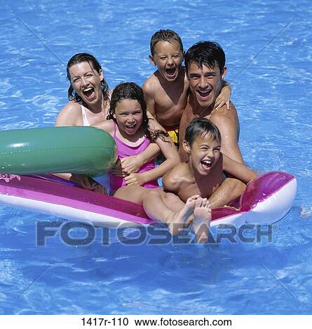 Father and mother with their daughter and sons in a swimming pool View Large Photo Image Stock Image - Father and mother with their daughter and sons in a swimming pool. Fotosearch