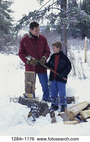 Stock Photograph - Father and son cutting wood. Fotosearch