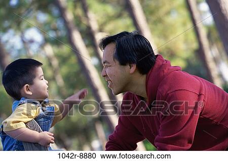 Father and son looking at each other View Large Photo Image Stock Image - Father and son looking at each other. Fotosearch