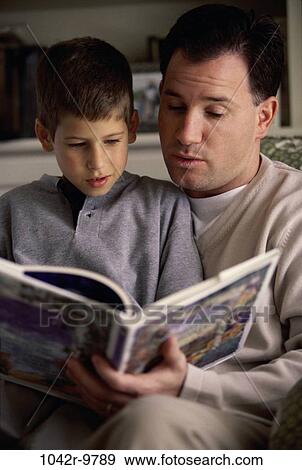 Stock Photo - Father and son reading a book. Fotosearch