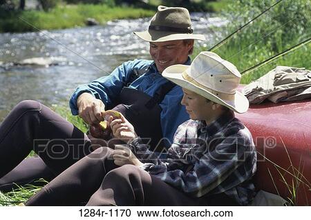 Father and son sharing an apple View Large Photo Image Stock Image - Father and son sharing an apple. Fotosearch