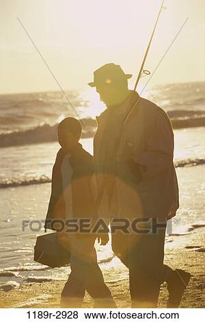 Father and son walking on the beach View Large Photo Image Stock Photo - Father and son walking on the beach. Fotosearch