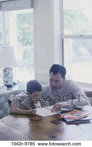 Stock Photography - Father assisting his son with his homework. Fotosearch