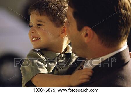 Stock Photography - Father carrying his son. Fotosearch