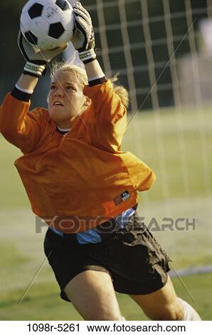 Female soccer goalie catching the ball View Large Photo Image Stock Image - Female soccer goalie catching the ball. Fotosearch