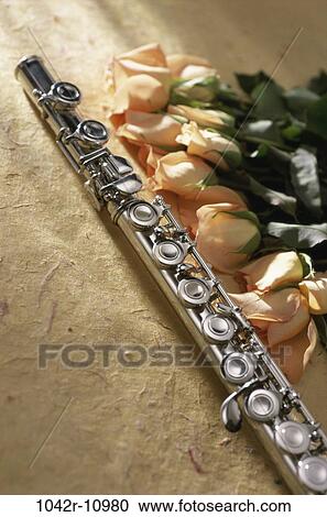 Stock Image - Flute near roses. Fotosearch