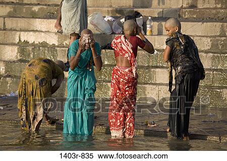 Four women wash in the Ganges River at the holy Hindu city of Varanasi, India in Uttar Pradesh state View Large Photo Image Stock Photography - Four women wash in the Ganges River at the holy Hindu city of Varanasi, India in Uttar Pradesh state. Fotosearch