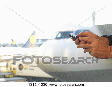 Germany, Frankfurt airport, Detail of man's hand sending text message View Large Photo Image Stock Image - Germany, Frankfurt airport, Detail of man's hand sending text message. Fotosearch